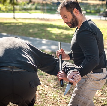 man using stick baton for defense